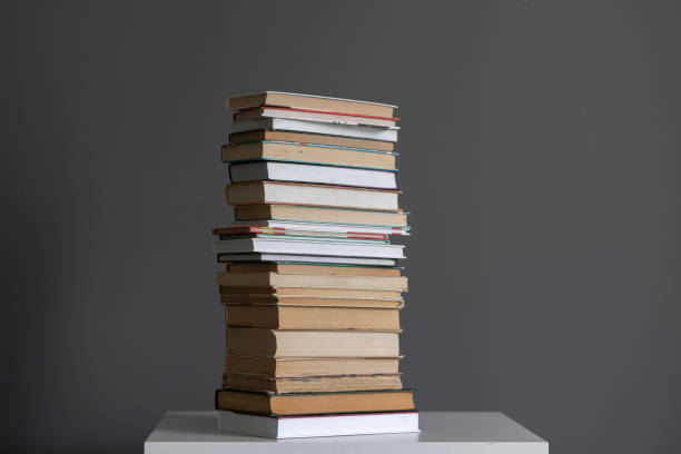 a stack of books on the shelf, concept of homework and studying stock photo