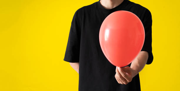 istock person holding balloon, happy holidays celebration 1423791815