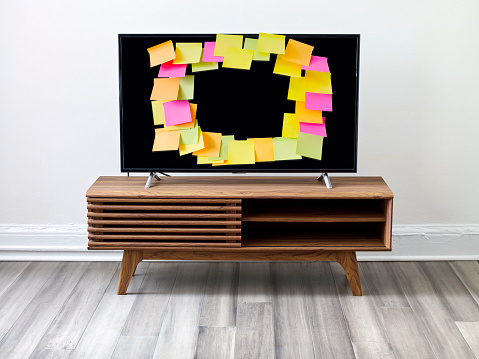 Adhesive notes attached on tv screen