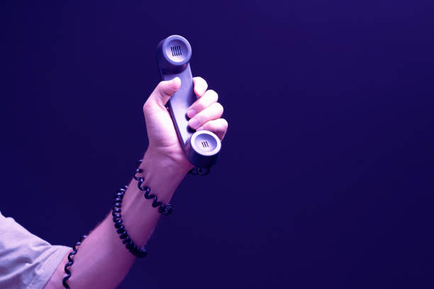 istock creative idea of hand holding old vintage telephone handset with cablw 1423794162