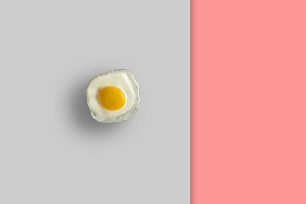 istock clean fried egg isolated on pastel background. minimalistic food concept 1423794184