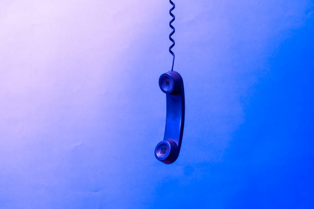 simple dark old telephone handset with cable. on pastel background