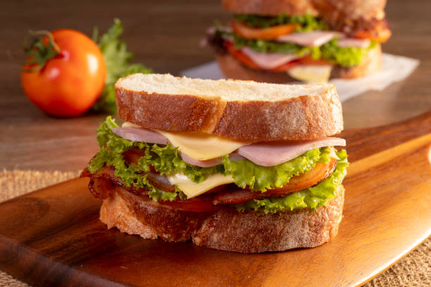 istock sandwich with ham and vegetables on a wooden table 1423797011