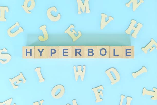 istock Hyperbole figure of speech figurative language concept in English grammar class lesson. Wooden blocks typography flat lay in blue background. 1423797542