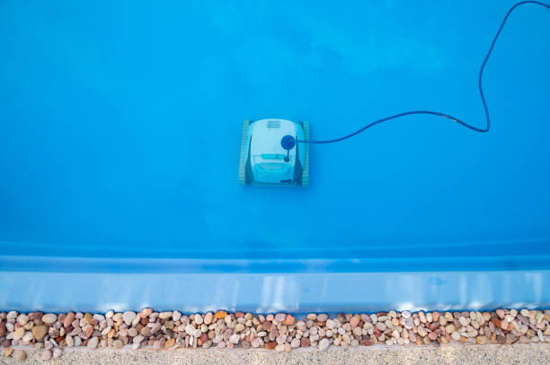 Robotic pool cleaner during on duty. Robotic is solutions for swimming pool care, deep clean pool surfaces, removing leaves for you. immersed in their work stock pictures, royalty-free photos & images