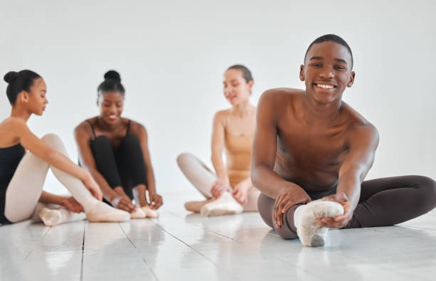 istock Shot of a young boy practicing his ballet routine with his classmates in the background 1423797795