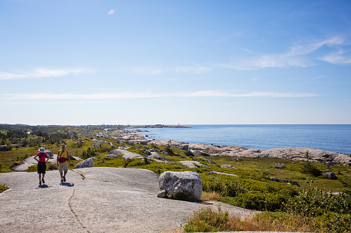Peggy's Cove, Canada - August 29, 2022. Two adults walk near the Swissair Flight 111 memorial in Nova Scotia.