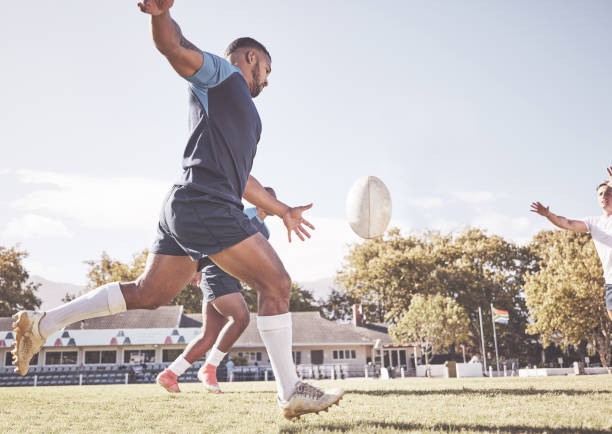istock Mixed race rugby player attempting a dropkick during a rugby match outside on the field. Hispanic man kicking for touch or attempting to score three points during a game. Getting his team up the field 1423804547