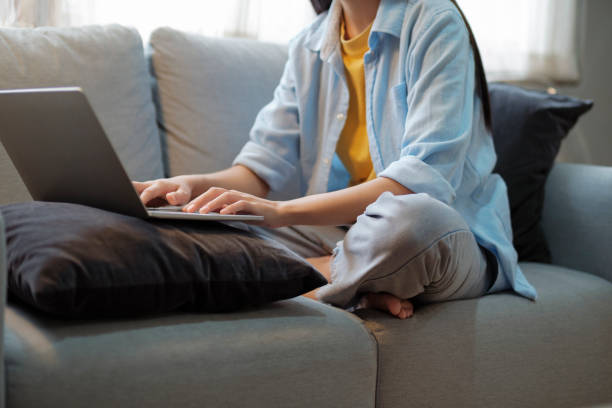 istock Close up of women working and studying using laptop at home. 1423808577