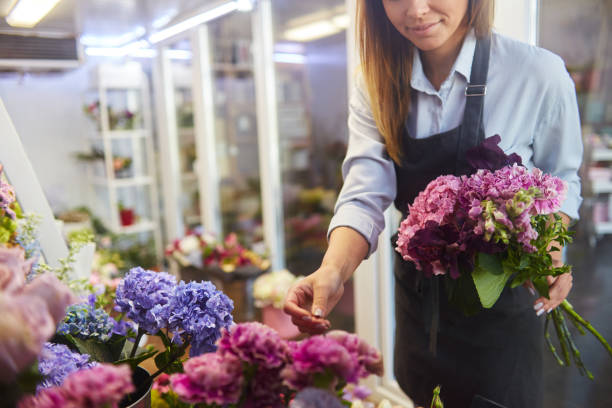 istock Female florist selecting fresh flowers for bouquet 1423809204