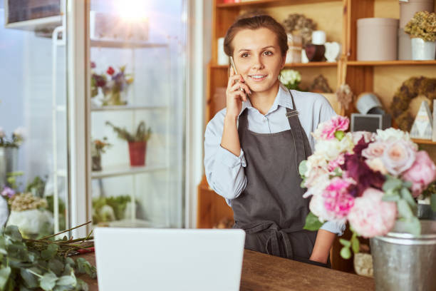 istock Female florist customer service on the phone 1423809247