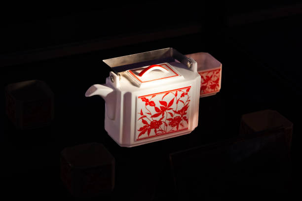 chinese tea cup and teapot on black background