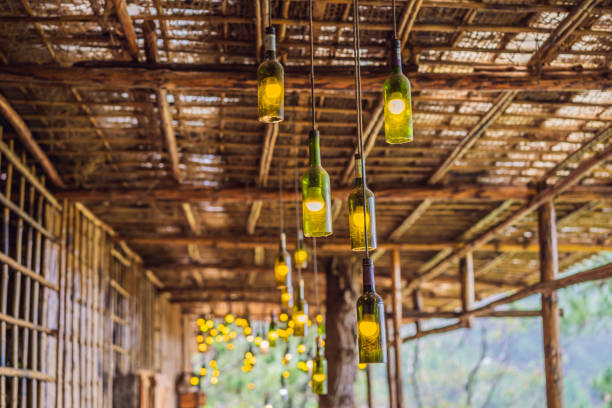 istock Beautiful retro light lamp decor made of empty wine bottles. Toned 1423818267