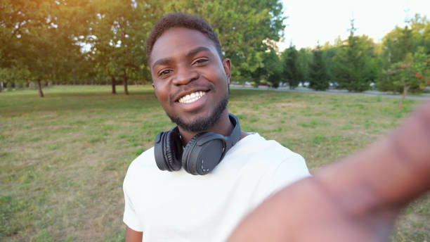 istock African American man records video on smartphone smiling 1423820045