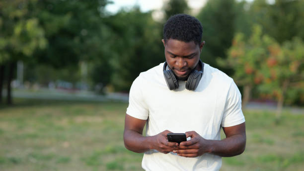 istock African American man walks typing messages on smartphone 1423820048