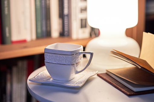 Porcelain cups, beautiful porcelain cups arranged on rustic wood, dark background, selective focus.