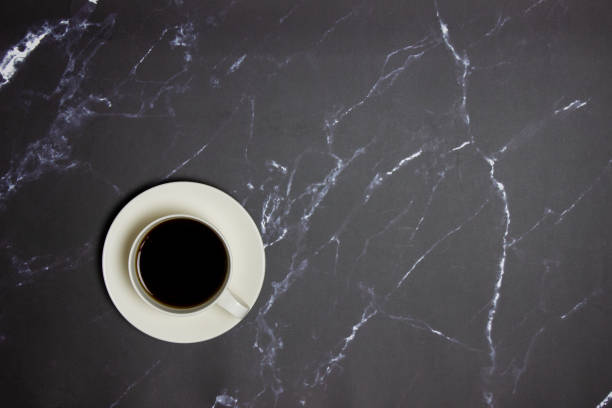 istock Black coffee over the black marble background with copy space. 1423823809