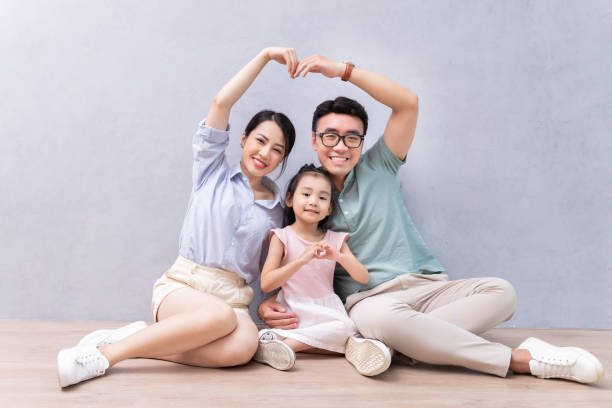 istock Young Asian family sitting on the floor 1423826921