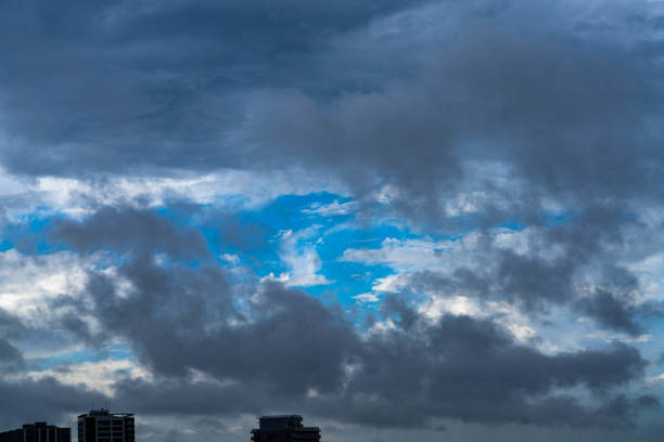 Typhoon is approaching and the sky covered by dark cloud but still we can see the blue and sun lighted sky through it. The light at the end of tunnel.