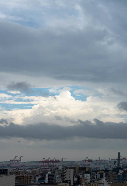 istock Blue and light sky through dark cloud created by typhoon with Tokyo sky buildings 1423830438