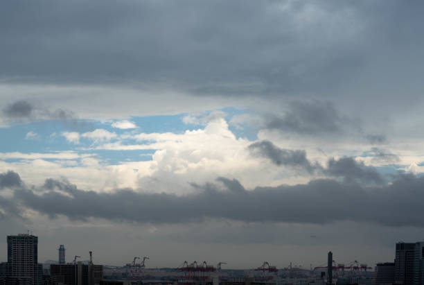 Typhoon is approaching and the sky covered by dark cloud but still we can see the blue and sun lighted sky through it. The light at the end of tunnel.