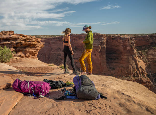 istock Young couple preparing the ropes for high-lining/slacklines 1423835337
