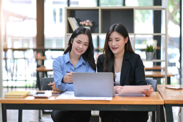 istock Two Young Asian businesswoman discuss with new startup project Idea presentation, analyze planning and financial statistics and investment market at office. 1423836315