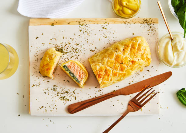 istock Homemade salmon strudel on table, top view 1423839325