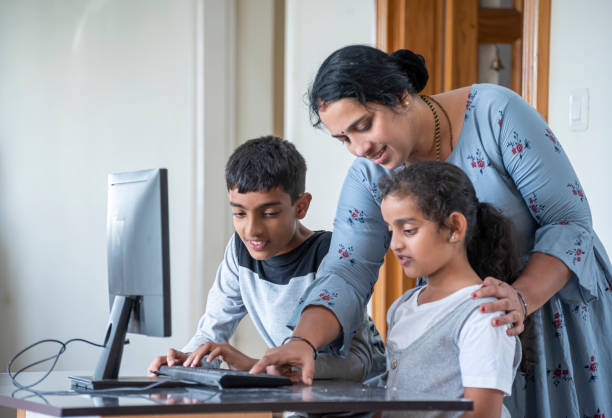 istock mother teaching with  pc at home 1423841857