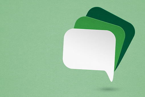 three speech bubbles paper  cut on grunge green background, for communication and social media, customer feedback concept