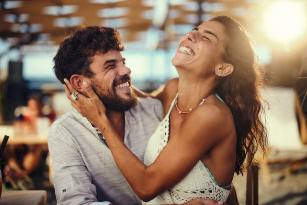 istock Young cheerful couple having fun in summer day. 1423843589