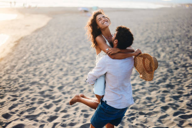 istock Carefree couple having fun on the beach. 1423845018