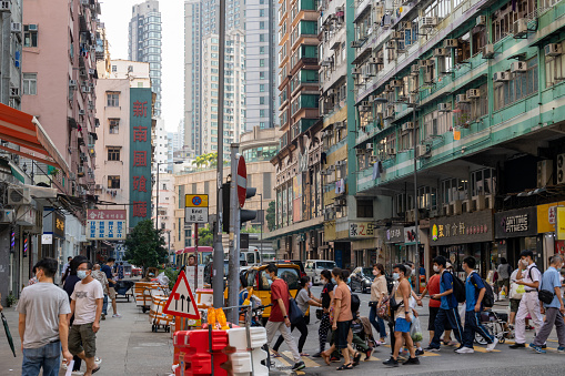 Hong Kong - September 13, 2022 : Pedestrians wearing face masks at To Kwa Wan, Kowloon, Hong Kong.