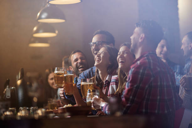 istock Cheerful friends having fun during night out in a bar. 1423847644