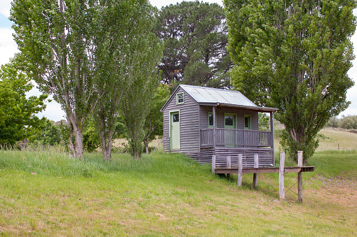 Daylesford, Victoria / Australia - November 1 2014:  Side view of an inviting and charming small home surrounded by trees and nature at Lavandula lavender Farm. Isolated off-grid tiny house concept.