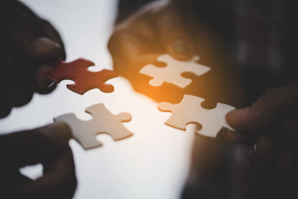 istock Hands holding piece of blank jigsaw puzzle for teamwork 1423852694