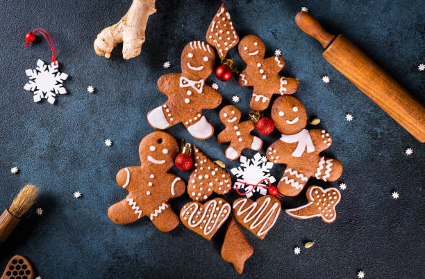 istock christmas tree made from gingerbread cookies on dark blue background with copy space for text. Gingerbread cookie with kitchen utensils. new year and christmas postcard. Assorted cookies. 1423852702