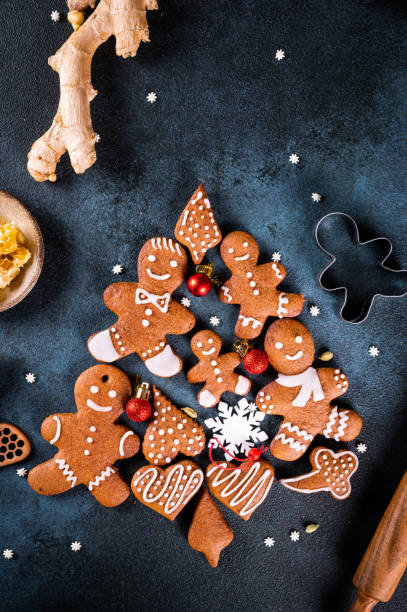 istock christmas tree made from gingerbread cookies on dark blue background with copy space for text. Gingerbread cookie with kitchen utensils. new year and christmas postcard. Assorted cookies. 1423852710