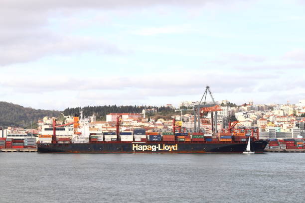 Lisbon, Portugal - February 16, 2022:  Container ship, Sounion Trader, is pictured docked on the Tagus River in Lisbon.  The ship is owned by Hapag Lloyd and was built in 2003.