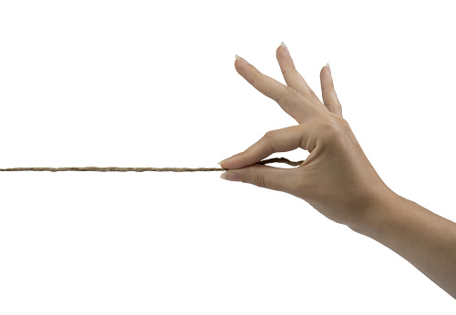 the thread held by a female hand on a white background