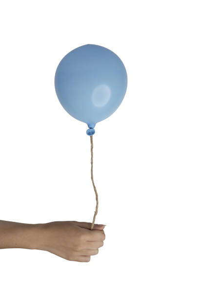 istock a blue balloon in the female hand 1423865746