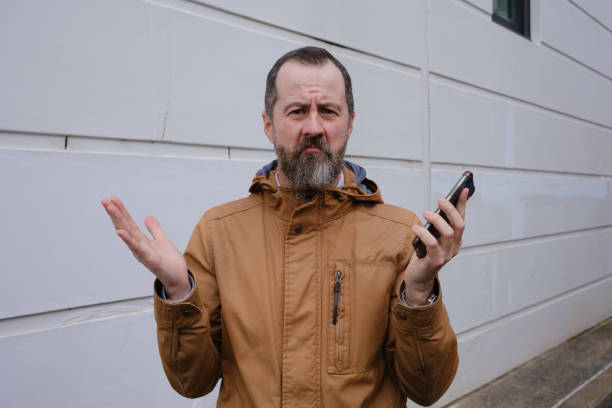 istock A man standing with his smartphone. 1423866812