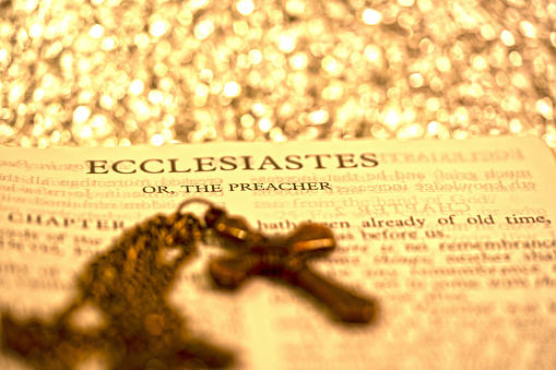 Holy bible book of Ecclesiaste or The Preacher for background and inspiration with silver glitter bokeh