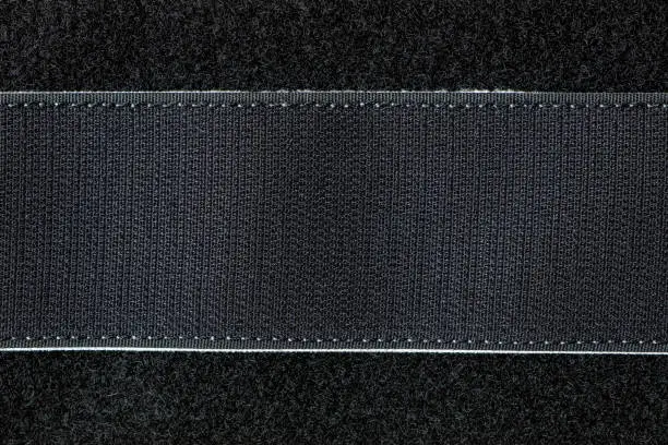 Velcro strip in black color close-up as a background