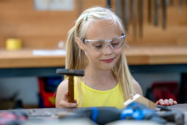 istock Girl holding hammer 1423875513