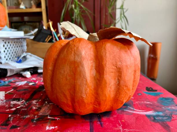 istock Papier Mache Pumpkin Painting in Progress 1423879145