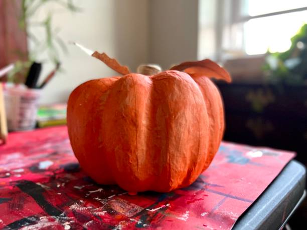 istock Papier Mache Pumpkin Painting in Progress 1423879662