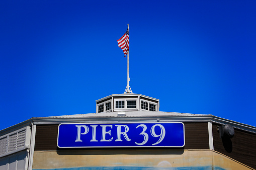 San Frrancisco, Sep 9 2022 - The famous Pier 39 sign with American flag in the background