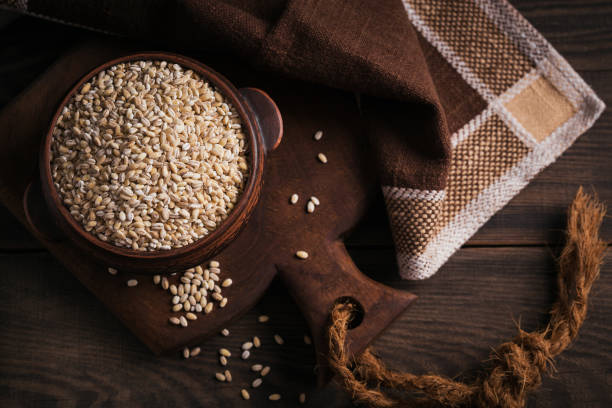 istock Bowl of raw dried broken pearl barley cereal grain 1423882028