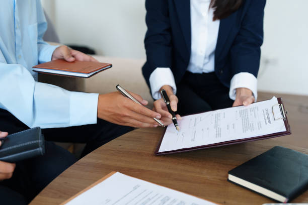 istock Couples sign important documents with insurance agents 1423882356